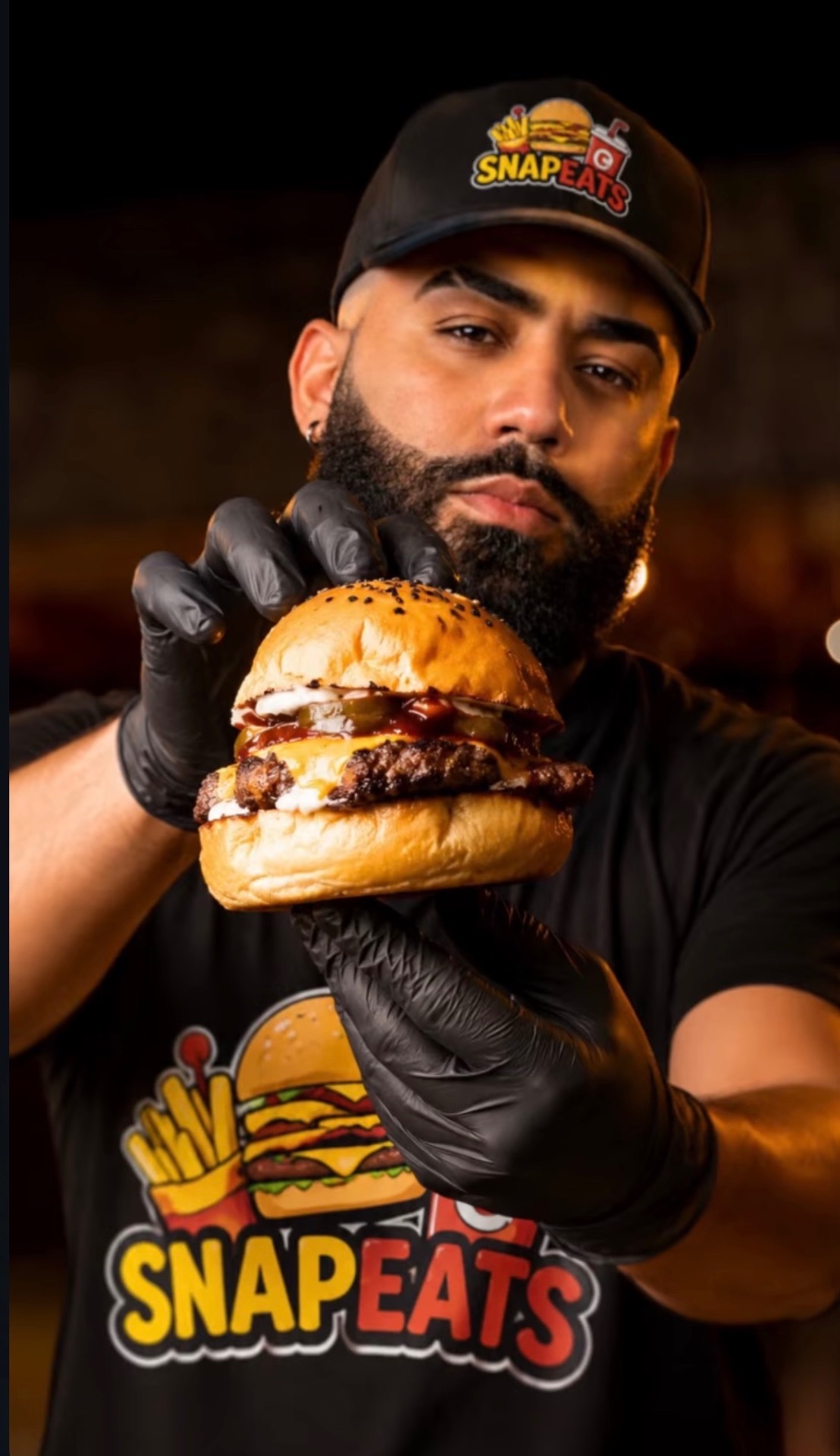 SnapEats owner holding a double smash burger